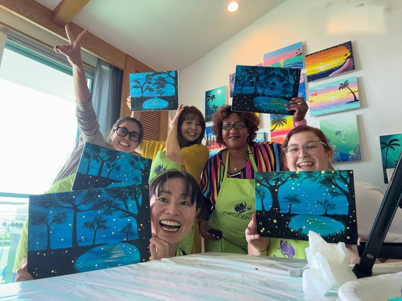 Group of Pinto Beetle guests holding finished blue paintings