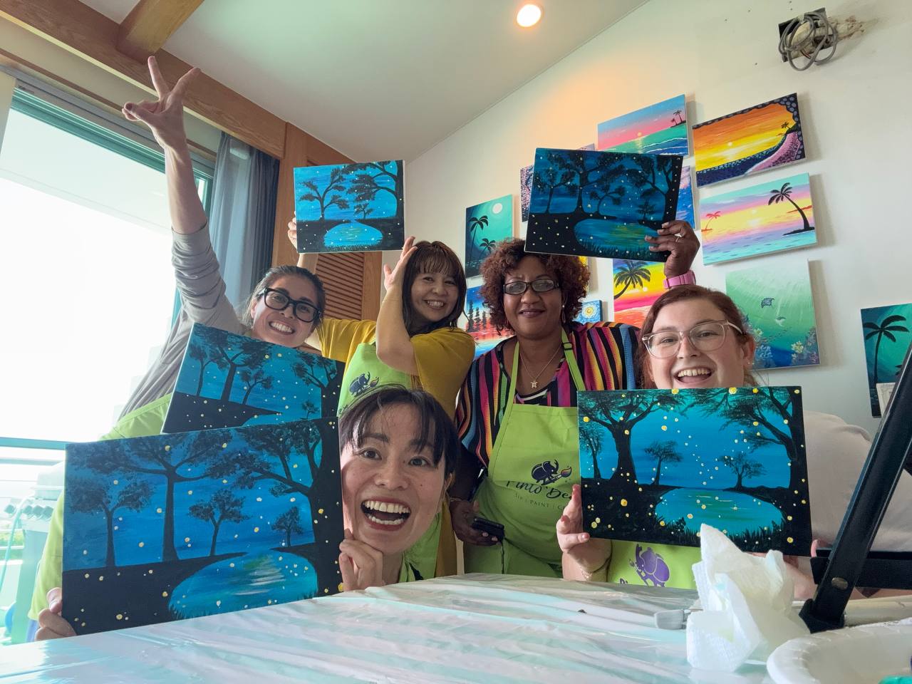Pinto Beetle guests smiling with finished moonlit cherry blossom paintings