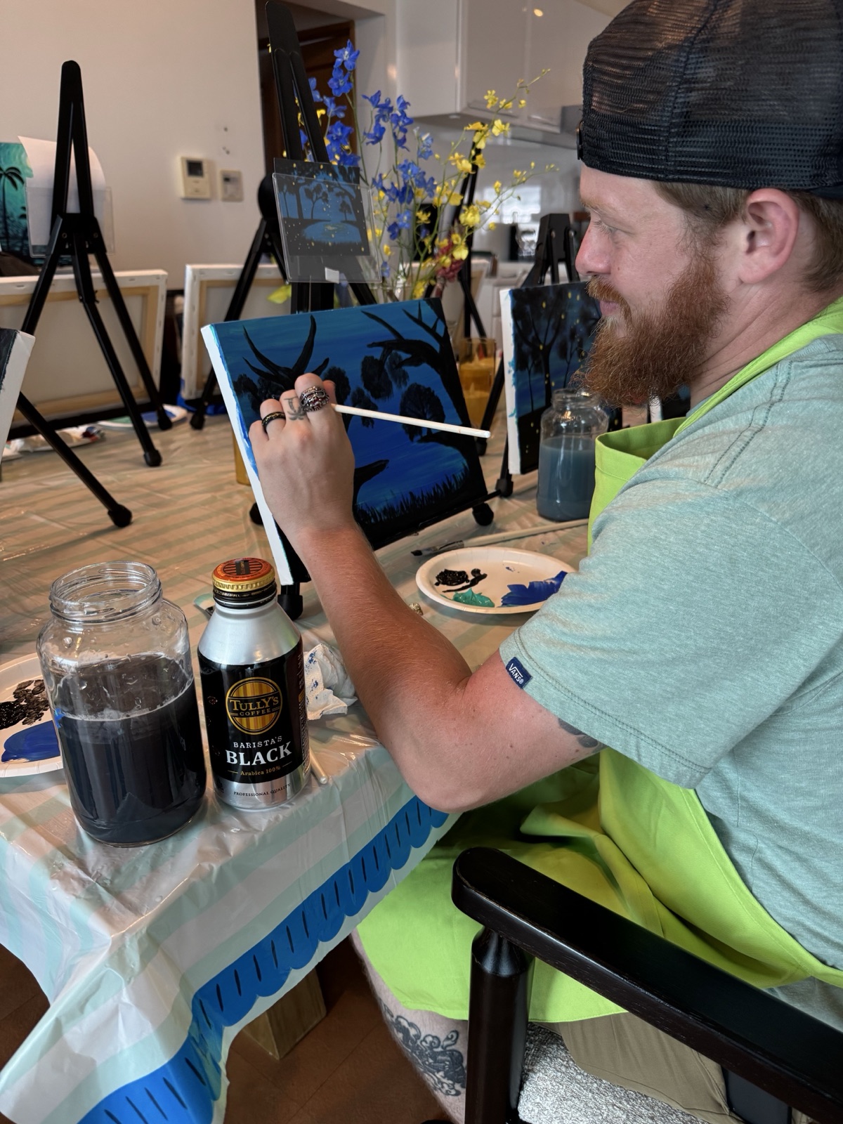 Pinto Beetle guest painting a firefly forest canvas during class