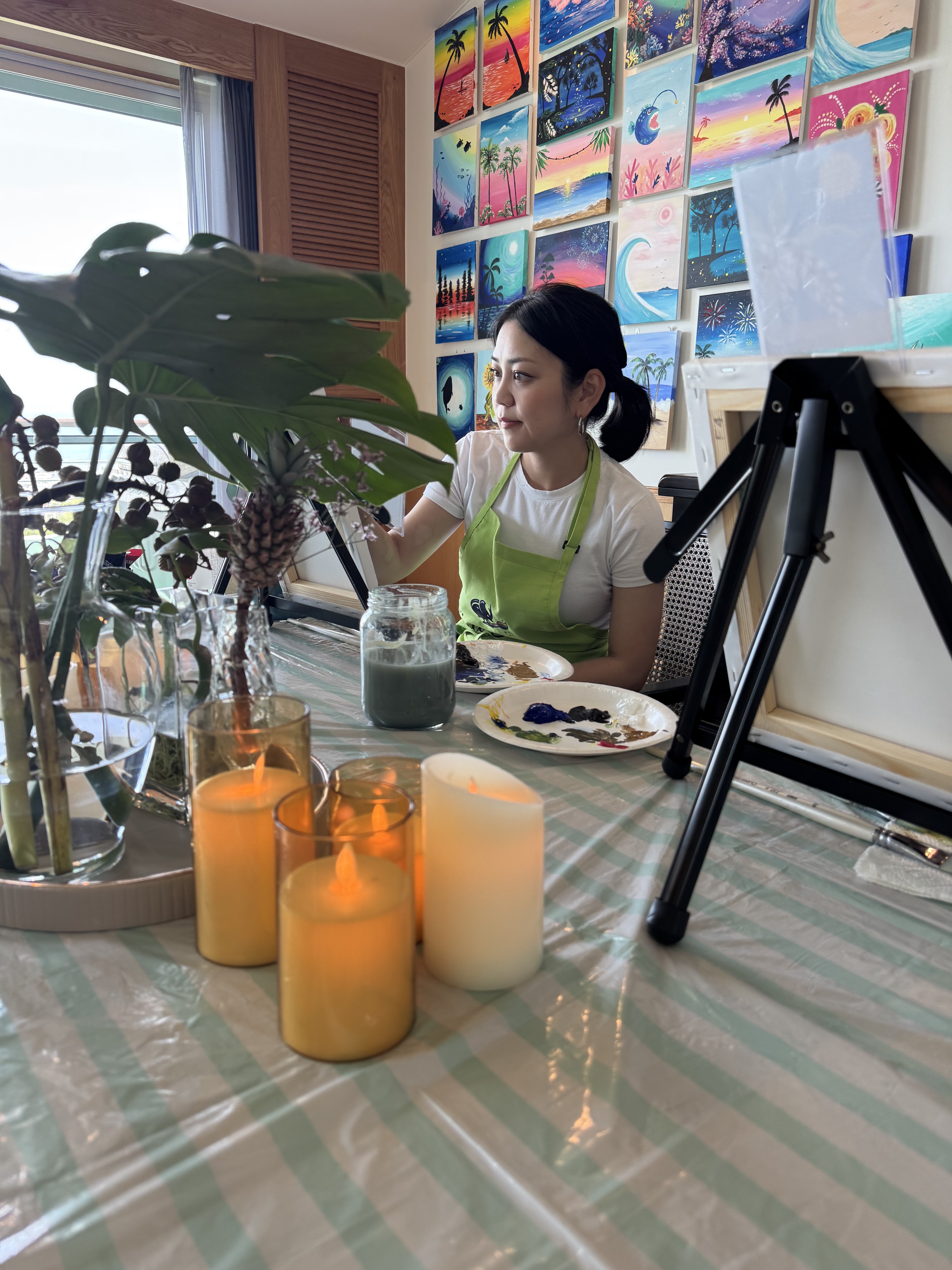 Pinto Beetle guest painting in the ocean-view studio with candles and artwork on the wall