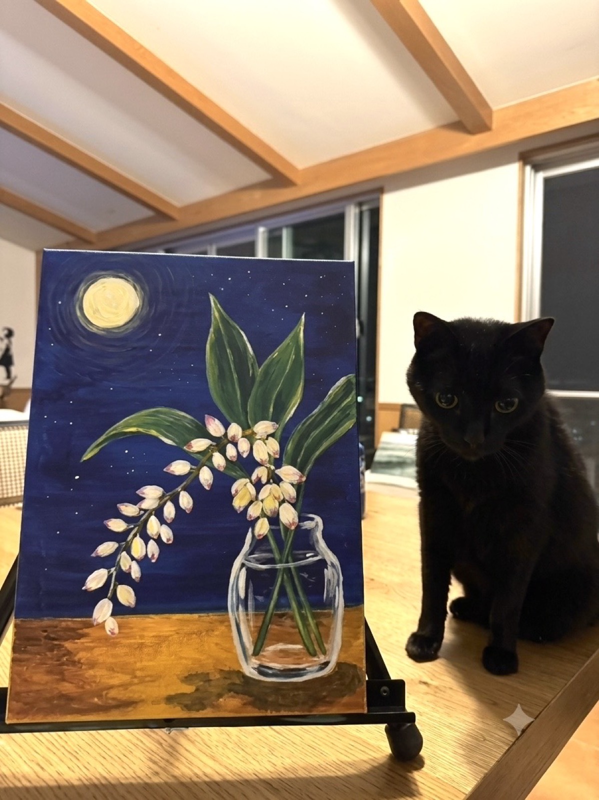 Moonlit getto painting displayed beside the Pinto Beetle studio cat