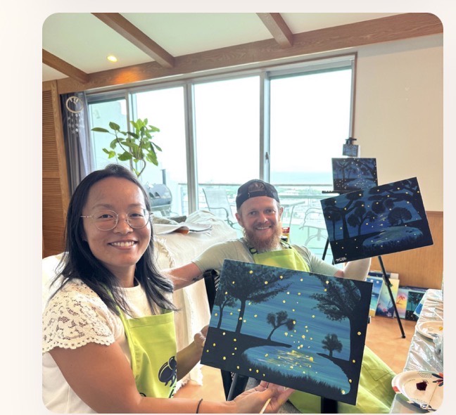 Pinto Beetle guests smiling with finished Moonlit Getto paintings