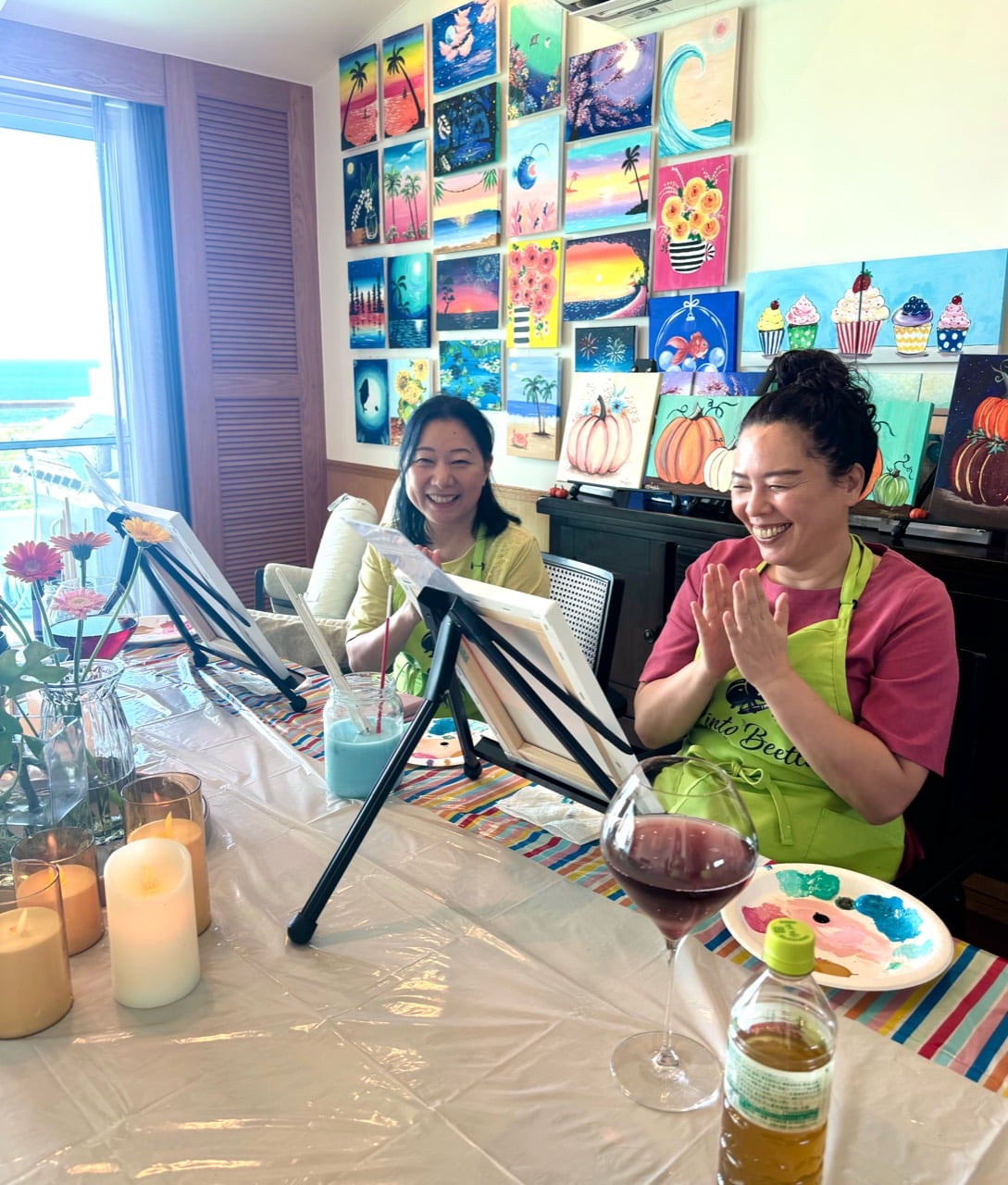 Pinto Beetle guests smiling at the painting table during a pink moon wave class