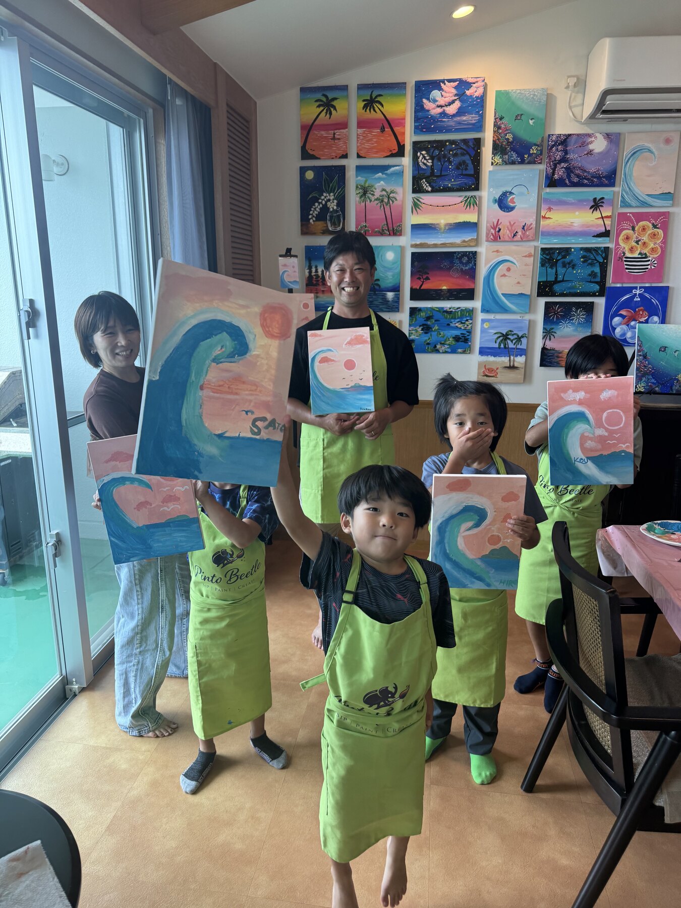 Pinto Beetle family group smiling with finished pink wave paintings