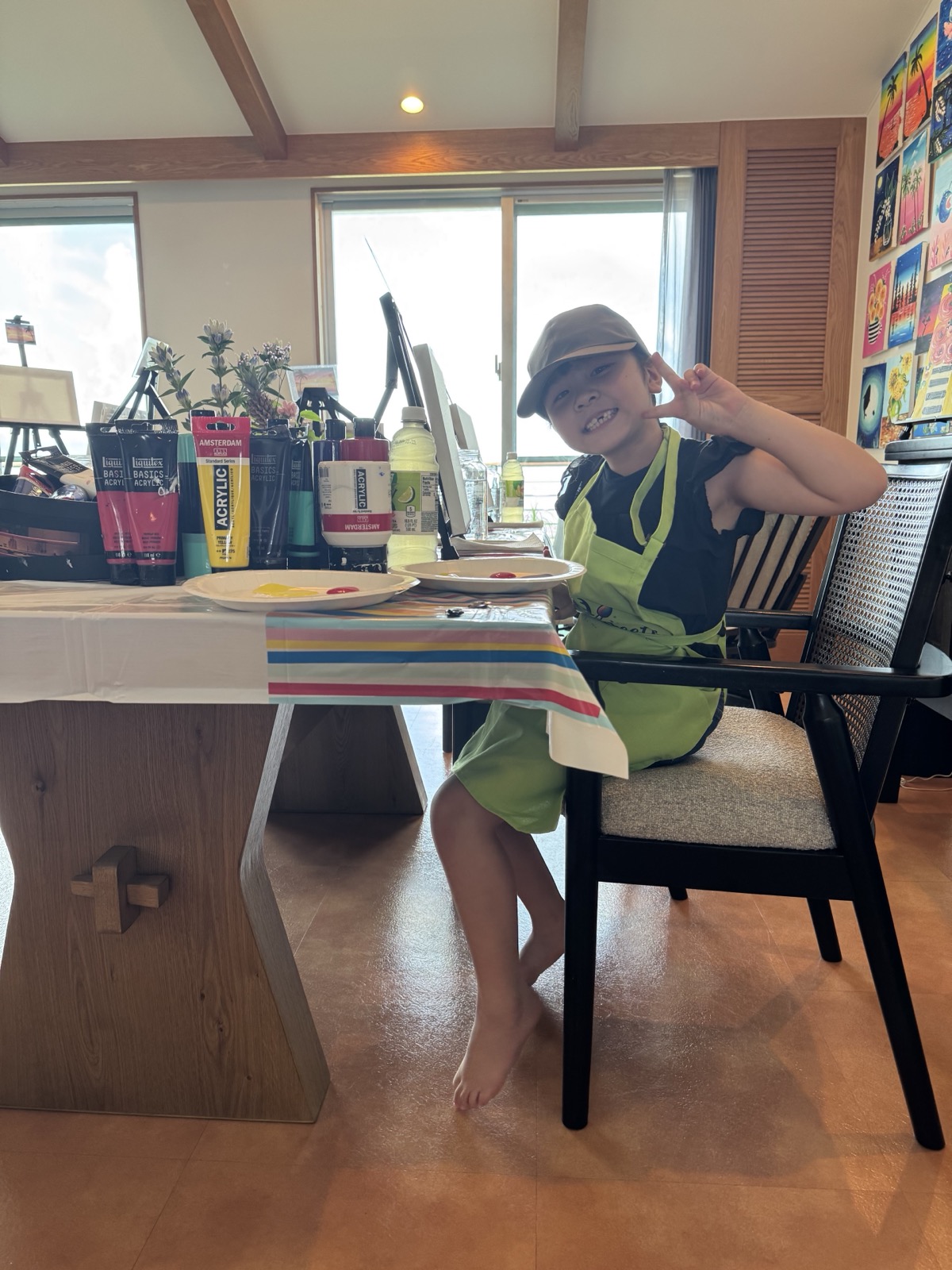 Young Pinto Beetle guest smiling at the painting table before class