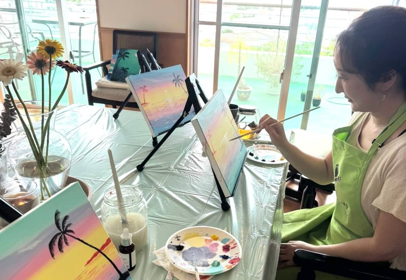 Pinto Beetle guest painting a sunset canvas by the ocean-view windows